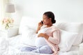 Happy pregnant woman calling on smartphone at home Royalty Free Stock Photo