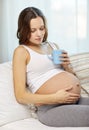 Happy pregnant woman with cup drinking tea at home Royalty Free Stock Photo
