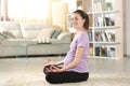 Pregnant woman doing yoga at home looking at you Royalty Free Stock Photo