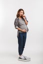 happy pregnant woman eating chocolate while standing Royalty Free Stock Photo