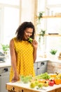 Happy pregnant woman eating lettuce in her kitchen. Royalty Free Stock Photo