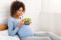 Happy pregnant woman eating natural vegetable salad Royalty Free Stock Photo