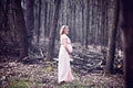Happy pregnant woman enjoying walk in forest Royalty Free Stock Photo
