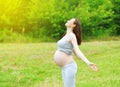 Happy pregnant woman enjoys sunny summer day Royalty Free Stock Photo