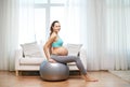 Happy pregnant woman exercising on fitball at home Royalty Free Stock Photo