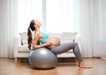 Happy pregnant woman exercising on fitball at home Royalty Free Stock Photo