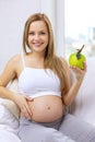 Happy pregnant woman with fresh green apple Royalty Free Stock Photo