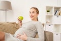 Happy pregnant woman with green apple Royalty Free Stock Photo