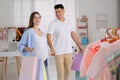 Happy pregnant woman and her husband with shopping bags in store Royalty Free Stock Photo