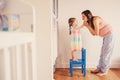 Happy pregnant woman with her toddler daughter at home Royalty Free Stock Photo