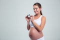 Happy pregnant woman holding alarm clock Royalty Free Stock Photo