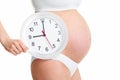 Happy pregnant woman holding clock Royalty Free Stock Photo