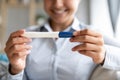 Happy pregnant woman holding pregnancy test in hands, closeup view Royalty Free Stock Photo