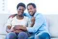 Happy pregnant woman with husband sitting at home Royalty Free Stock Photo