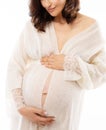 Happy Pregnant Woman looking at Belly. Maternity Care and Healthy Pregnancy. Smiling Mother embracing Abdomen preparing for Child Royalty Free Stock Photo