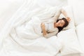 Happy pregnant woman lying in bed at home Royalty Free Stock Photo