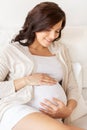 Happy pregnant woman lying on bed at home Royalty Free Stock Photo