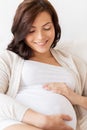 Happy pregnant woman lying on bed at home Royalty Free Stock Photo