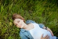 Happy pregnant woman lying on the grass Royalty Free Stock Photo