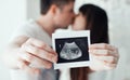 Happy pregnant woman and man with ultrasound picture of baby Royalty Free Stock Photo
