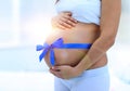 Happy pregnant woman measuring her tummy and waist. Royalty Free Stock Photo