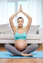 Happy pregnant woman meditating at home Royalty Free Stock Photo