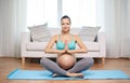 Happy pregnant woman meditating at home Royalty Free Stock Photo