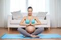 Happy pregnant woman meditating at home Royalty Free Stock Photo