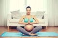 Happy pregnant woman meditating at home Royalty Free Stock Photo