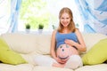 Happy pregnant woman with a picture smiley on belly