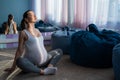 Happy pregnant woman practice yoga. A girl in the third trimester leads Pilates. Classes to prepare for childbirth