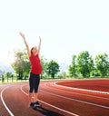 Happy pregnant woman with raised hands on sport stadium. Royalty Free Stock Photo