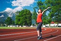 Happy pregnant woman with raised hands on sport stadium. Royalty Free Stock Photo