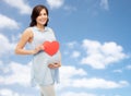 Happy pregnant woman with red heart touching belly Royalty Free Stock Photo