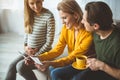 Happy pregnant woman showing photo of her unborn child