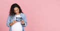 Happy pregnant woman showing ultrasound image of her baby Royalty Free Stock Photo