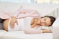 Happy pregnant woman sleeping on sofa at home Royalty Free Stock Photo