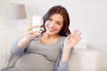 Happy pregnant woman with smartphone at home Royalty Free Stock Photo