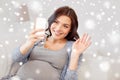 Happy pregnant woman with smartphone at home Royalty Free Stock Photo