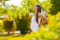 Happy pregnant woman standing in garden holding on tummy Royalty Free Stock Photo