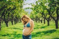 Happy pregnant woman in swimwaer and jeans in harmony with the nature