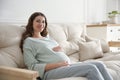 Happy pregnant woman touching her belly indoors Royalty Free Stock Photo