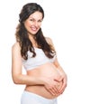 Happy pregnant woman touching her belly Royalty Free Stock Photo