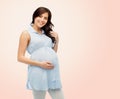 Happy pregnant woman touching her big belly Royalty Free Stock Photo