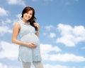 Happy pregnant woman touching her big belly Royalty Free Stock Photo