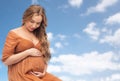 Happy pregnant woman touching her big belly Royalty Free Stock Photo
