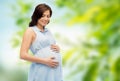 Happy pregnant woman touching her big belly Royalty Free Stock Photo