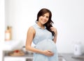 Happy pregnant woman touching her big belly Royalty Free Stock Photo