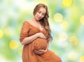 Happy pregnant woman touching her big belly Royalty Free Stock Photo