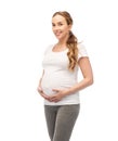 Happy pregnant woman touching her big belly Royalty Free Stock Photo